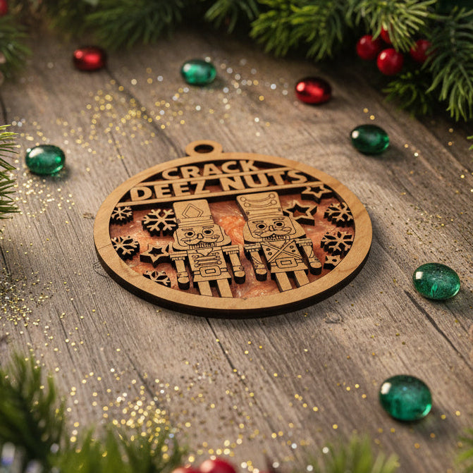 Wooden ornament with 'Off Track Nuts' text on a wooden surface with Christmas decorations.