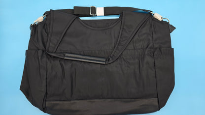 Black weekender tote, three-quarter angle showing carry handles and silhouette.