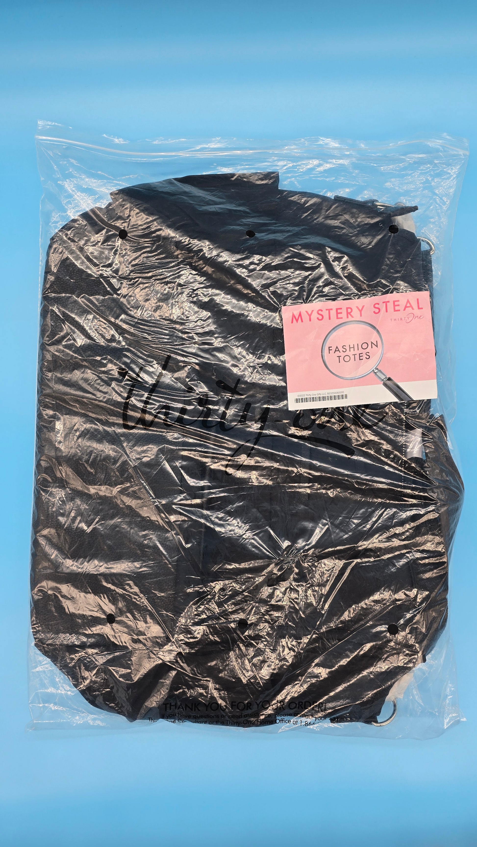 Model carrying Black Beauty tote over shoulder, airport setting.